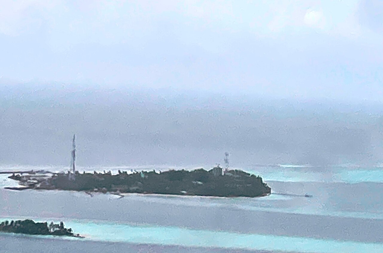 Aerial view of Dhangethi Island in South Ari Atoll, Maldives, showing the village and surrounding reef