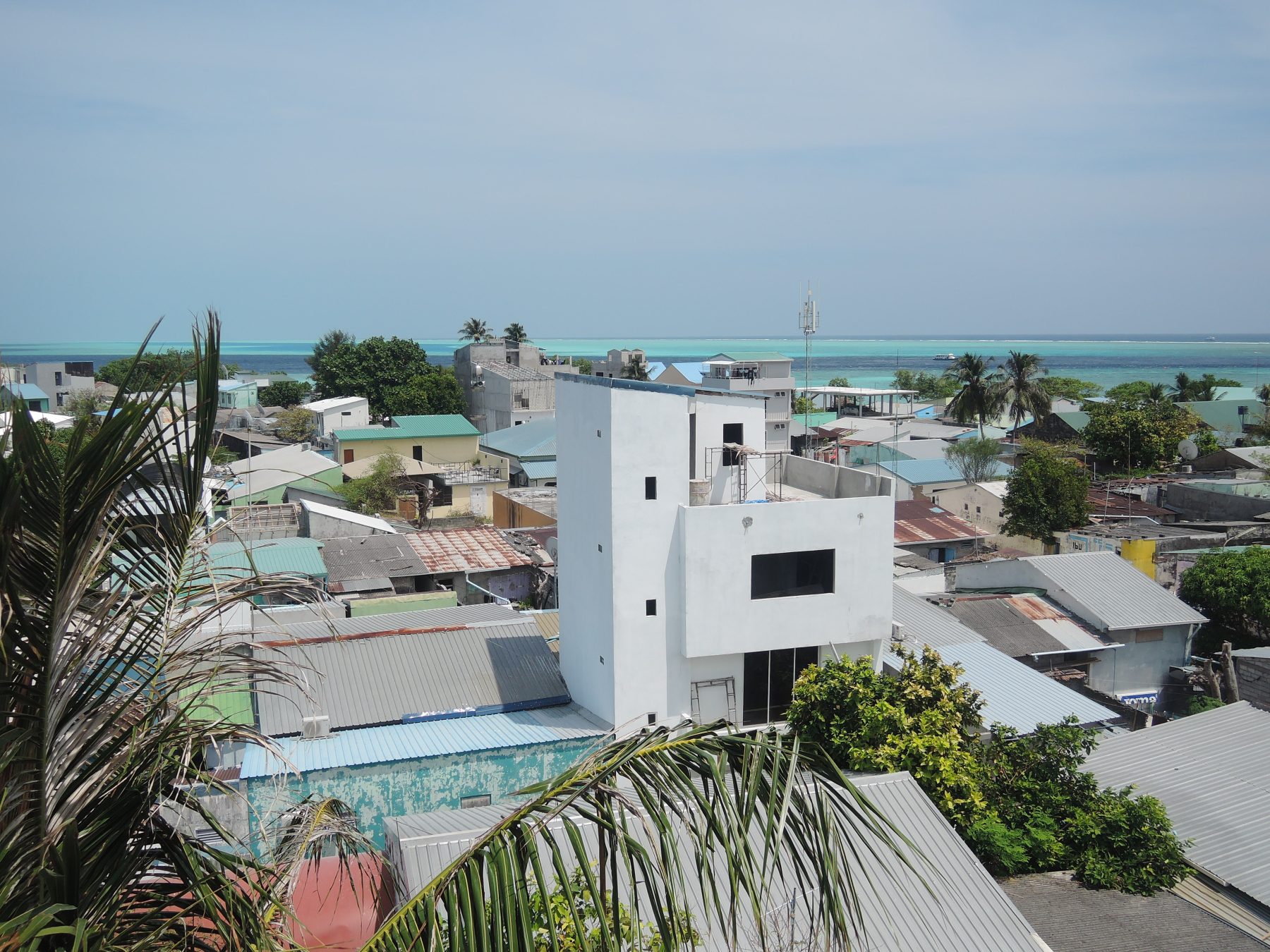 Rooftop view over the village of Gulhi Island, South Male Atoll, Maldives, with the lagoon and reef in the background