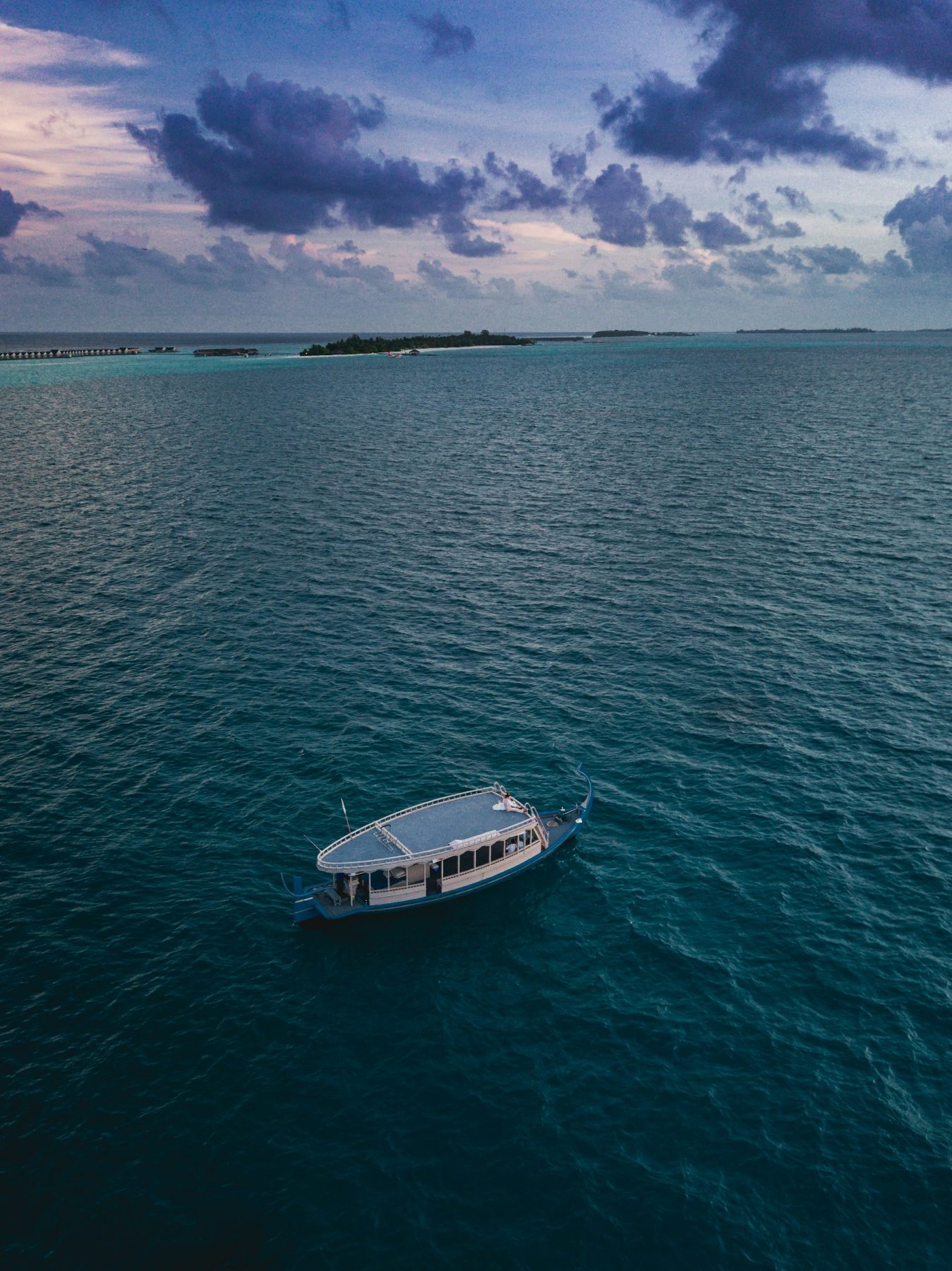 A traditional Maldivian dhoni boat anchored near an island lagoon at dusk (representative photo, not Gulhi itself)