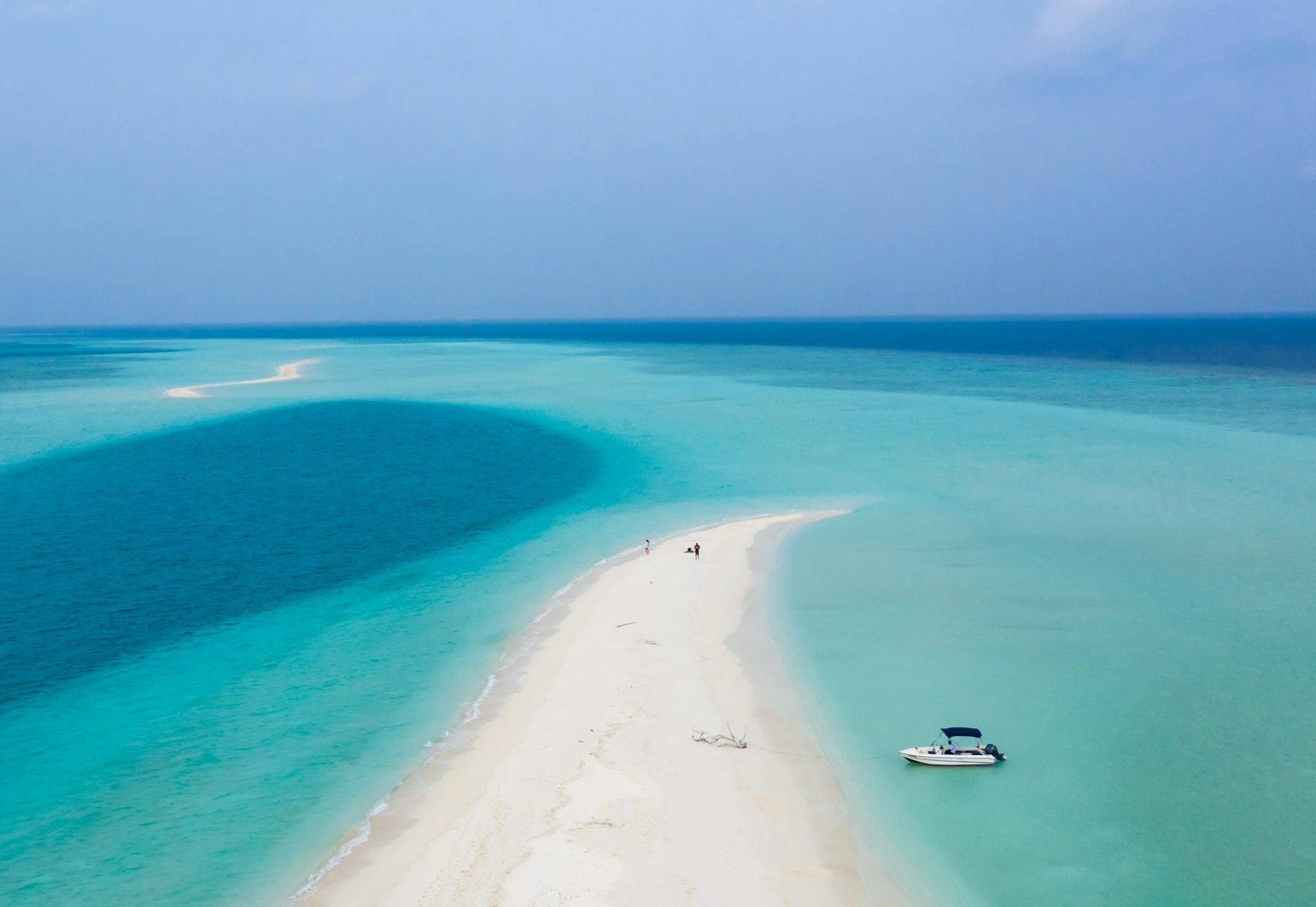 A boat on calm blue lagoon water in the Maldives (representative photo, not taken at Rasdhoo)